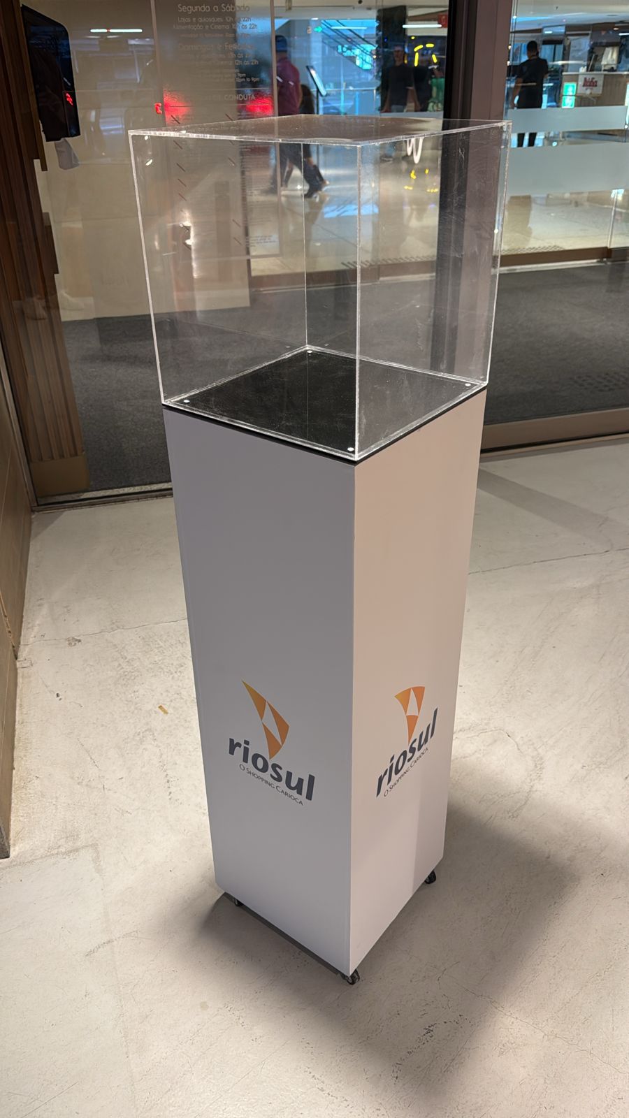 Pedestal expositor RioSul — estrutura com vitrine acrílica e logotipo do shopping carioca